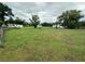 Spacious lot with sheds, mobile home, and a house, enclosed by a wire fence at 1886 Pleasant Hill Rd, Kissimmee, FL 34746