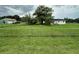 Spacious, grassy yard with a chainlink fence surrounds this single-Gathering home at 1886 Pleasant Hill Rd, Kissimmee, FL 34746