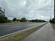 Scenic roadway view with light traffic and lush green landscaping, ideal for easy commuting at 1886 Pleasant Hill Rd, Kissimmee, FL 34746