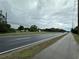Scenic roadway view with light traffic and lush green landscaping, ideal for easy commuting at 1886 Pleasant Hill Rd, Kissimmee, FL 34746
