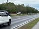 Street view showcasing the property and vehicular traffic on a rainy day at 1886 Pleasant Hill Rd, Kissimmee, FL 34746