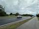 Roadside view of properties, showing street access and nearby businesses at 1886 Pleasant Hill Rd, Kissimmee, FL 34746