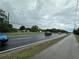 Roadside view of properties, showing street access and nearby businesses at 1886 Pleasant Hill Rd, Kissimmee, FL 34746