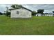 View of the side of the home showing the yard, shed, and other structures on the property at 1886 Pleasant Hill Rd, Kissimmee, FL 34746