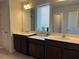 Bathroom features dual sinks and vanities providing convenience and style at 1896 Basenji Dr, Lake Alfred, FL 33850