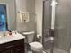 Modern bathroom with a glass-enclosed shower, stylish vanity, and neutral color palette at 1896 Basenji Dr, Lake Alfred, FL 33850