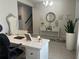 Well-appointed home office featuring a decorative mirror, accent furniture, and natural lighting at 1896 Basenji Dr, Lake Alfred, FL 33850