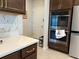 Kitchen features stainless steel double ovens, white countertops, and elegant dark cabinets at 1896 Basenji Dr, Lake Alfred, FL 33850