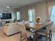 Comfortable living and dining areas with tile flooring, neutral decor, and ample natural light at 1896 Basenji Dr, Lake Alfred, FL 33850