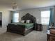 The main bedroom features a decorative chandelier and decorative furniture at 1896 Basenji Dr, Lake Alfred, FL 33850
