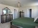 The main bedroom features a decorative chandelier and decorative furniture at 1896 Basenji Dr, Lake Alfred, FL 33850