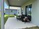 Covered patio shows outdoor seating, providing an inviting and shady place to relax and enjoy the backyard at 1896 Basenji Dr, Lake Alfred, FL 33850