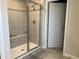 Modern tiled shower with a built-in bench provides a luxurious bathing experience at 1896 Basenji Dr, Lake Alfred, FL 33850