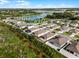 Community aerial view showcases well-maintained homes, green spaces, and a scenic lake at 1951 Partin Terrace Rd, Kissimmee, FL 34744