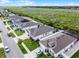 Aerial view of a neighborhood showcasing the home, street, and surrounding landscape at 1951 Partin Terrace Rd, Kissimmee, FL 34744