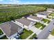 Beautiful aerial view of modern homes, manicured lawns, and a green space with a clear blue sky at 1951 Partin Terrace Rd, Kissimmee, FL 34744