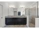 Bathroom featuring double sinks with granite countertop and a walk-in shower at 1951 Partin Terrace Rd, Kissimmee, FL 34744
