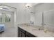 Bathroom features granite countertops with double sinks, an overhead light fixture and a large mirror at 1951 Partin Terrace Rd, Kissimmee, FL 34744
