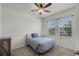 Cozy bedroom featuring two windows, neutral carpet, and ceiling fan at 1951 Partin Terrace Rd, Kissimmee, FL 34744