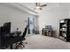 Large bedroom offering a ceiling fan, carpet, natural light, and ample space for a desk setup at 1951 Partin Terrace Rd, Kissimmee, FL 34744