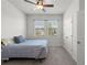 Bright bedroom with carpet, ceiling fan and a view of the neighborhood through two windows at 1951 Partin Terrace Rd, Kissimmee, FL 34744