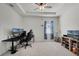 Bright bedroom with carpet, ceiling fan and a view of the neighborhood through the window at 1951 Partin Terrace Rd, Kissimmee, FL 34744