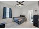 Bedroom featuring neutral carpet, ceiling fan, and ensuite bath at 1951 Partin Terrace Rd, Kissimmee, FL 34744