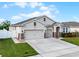 Charming home with a three-car garage, manicured lawn, and decorative stone accents at 1951 Partin Terrace Rd, Kissimmee, FL 34744