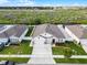 Well-maintained home featuring a spacious driveway, neat landscaping, and a charming front facade at 1951 Partin Terrace Rd, Kissimmee, FL 34744