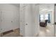 Inviting hallway leading to a cozy living room with a comfortable armchair at 1951 Partin Terrace Rd, Kissimmee, FL 34744