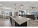 Granite kitchen island overlooking the dining and living areas, with pendant lighting at 1951 Partin Terrace Rd, Kissimmee, FL 34744