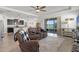 Comfortable living room with a ceiling fan and a sliding glass door leading to the outside at 1951 Partin Terrace Rd, Kissimmee, FL 34744