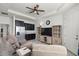 Cozy living room features built-in shelving and a convenient kitchenette area with stainless steel appliances at 1951 Partin Terrace Rd, Kissimmee, FL 34744