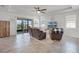 Bright living room with tile flooring, cozy seating, and sliding glass doors to the screened lanai at 1951 Partin Terrace Rd, Kissimmee, FL 34744