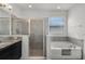 Bright main bathroom featuring a garden tub, separate shower, and granite countertop vanity at 1951 Partin Terrace Rd, Kissimmee, FL 34744
