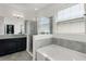Stylish main bathroom with a separate garden tub, shower, and granite countertop vanity at 1951 Partin Terrace Rd, Kissimmee, FL 34744