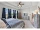Spacious main bedroom featuring a tray ceiling, ceiling fan, and many windows at 1951 Partin Terrace Rd, Kissimmee, FL 34744