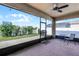 Enclosed porch with ceiling fan, lights, outdoor seating, and an expansive view of the lawn and backyard at 1951 Partin Terrace Rd, Kissimmee, FL 34744