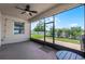 Enclosed porch with ceiling fan, lights, outdoor seating, and an expansive view of the lawn and backyard at 1951 Partin Terrace Rd, Kissimmee, FL 34744