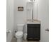 Powder room featuring a granite vanity, modern toilet, and framed butterfly art at 1951 Partin Terrace Rd, Kissimmee, FL 34744