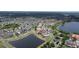 Expansive aerial view of a residential neighborhood featuring houses, ponds, and mature trees at 2016 Lakeside Ave, Davenport, FL 33837