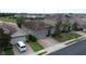 Aerial view of a home with a tile roof and brick driveway in a sunny residential community at 2016 Lakeside Ave, Davenport, FL 33837