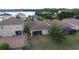 Aerial view showcasing homes with tile roofs plus screened in lanai and brick patio at 2016 Lakeside Ave, Davenport, FL 33837