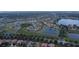 Expansive aerial shot showcases the community's layout, dotted with sparkling lakes amidst green landscapes and well-planned homes at 2016 Lakeside Ave, Davenport, FL 33837