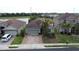 Aerial view of home featuring brick driveway, tile roof, lush landscaping and lake views at 2016 Lakeside Ave, Davenport, FL 33837
