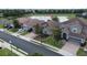 Aerial view of home with brick driveway, landscaping, lake, and community at 2016 Lakeside Ave, Davenport, FL 33837