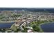 Aerial view of a serene community featuring tranquil lakes, well-maintained lawns and landscaping near neighborhood swimming pool at 2016 Lakeside Ave, Davenport, FL 33837