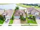 Aerial view of a single-Gathering home with a clay tile roof, brick driveway, and lush green lawn at 2016 Lakeside Ave, Davenport, FL 33837