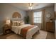 Comfortable bedroom with ceiling fan, neutral walls, stylish furnishings, and a decorative woven wall hanging at 2016 Lakeside Ave, Davenport, FL 33837