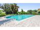 Large community pool with a brick-paved deck and mature trees providing shade and privacy at 2016 Lakeside Ave, Davenport, FL 33837